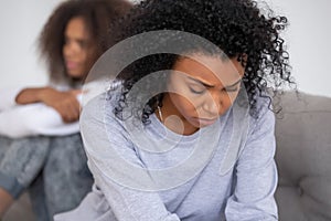 Upset african mom of teen daughter feeling sad after fight