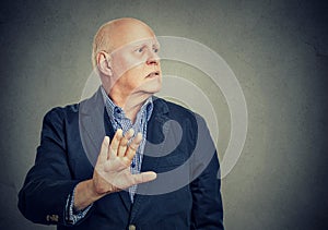 Upset annoyed man giving talk to my hand gesture