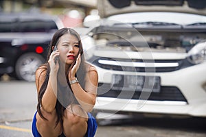 Upset Asian Japanese woman in stress stranded on street suffering car engine failure having mechanic problem calling on mobile