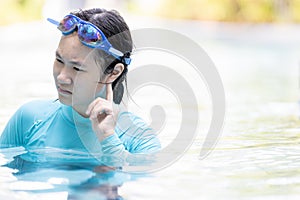 Upset asian teen girl had tinnitus,problem with water entering the ear canal while swimming,female people cleaning ears after photo