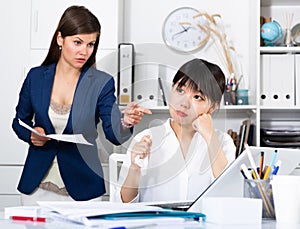 Upset asian woman with angry boss