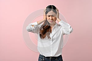 Upset Asian woman feeling unwell, having a headache