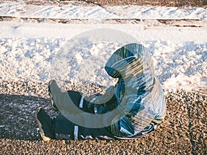 Upset baby boy sitting on asphalt road