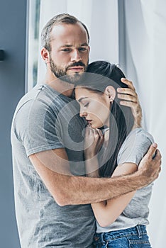 upset bearded man hugging and supporting depressed