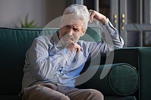 Upset bereaved old man widower mourning crying alone at home