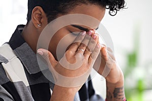 Upset black businesswoman feels unwell sitting in office