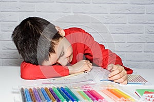 Upset boring schoolboy doing homework. Education, school, learning difficulties concept