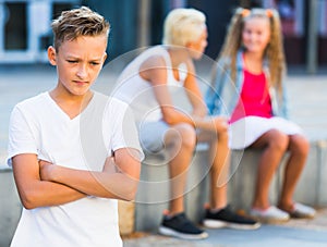 Upset boy after quarrel with playmates