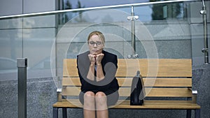 Upset business lady sitting on bench, lonely life of careerist without love