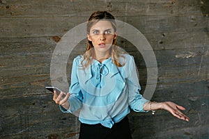 Upset business woman looks confused after talking on mobile phone