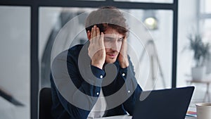 Upset businessman finding mistakes in documents. Frustrated man looking graphs photo