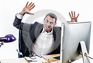 Upset businessman having a corporate tantrum at his computer desk