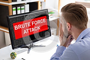 Upset Businessman Looking Brute Force Attack On Computer Screen