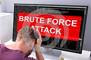 Upset Businessman Looking Brute Force Attack On Computer Screen