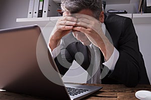 Upset Businessman Sitting In Office