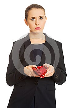 Upset businessswoman holding empty wallet