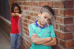 Upset child being teased by another child