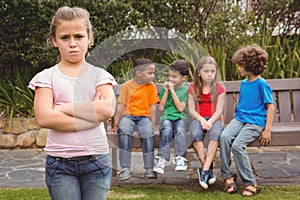 Upset child standing away from group