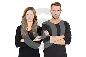 Upset couple standing with arms crossed