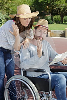 upset couple in wheelchair with map