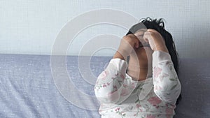 a upset crying child girl cover her face with hand sitting on sada