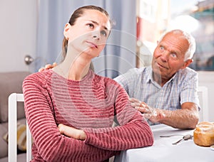 Upset daughter and senior man discussing, quarrel at home