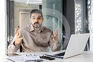 Upset and disappointed businessman looking at camera at workplace got negative financial results, portrait unhappy man