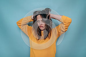 Upset disappointed woman holding head with tousled hair in hands. Depression, family misunderstandings