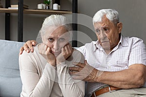 Upset elder husband comforting offended hurt senior wife