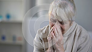 Upset elderly female patient crying in hospice, incurable disease, depression