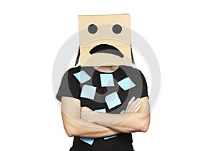 Upset employee with a box on his head, stress and problems in the office