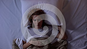 Upset female awakening in bed, disappointed with bad dream, suffering nightmares