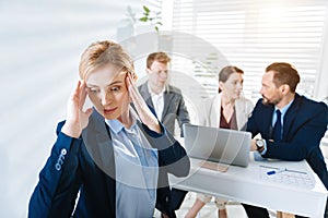 Upset female colleague experiencing stress at work