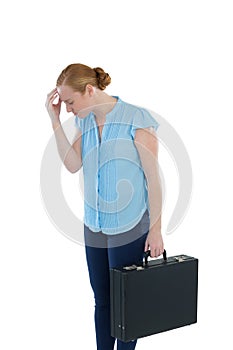 Upset female executive standing with briefcase