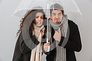 Upset frozen couple wearing autimn clothes