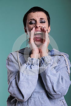 Upset frustrated female aggressively screeming in front of camera photo