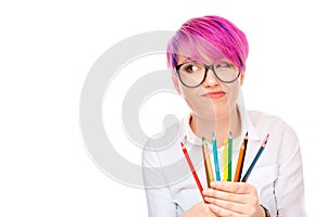 Upset girl holding set of colorful pencils