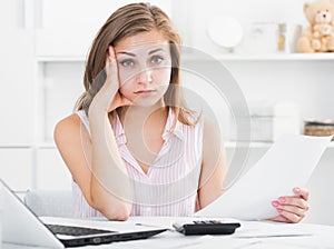 Upset girl looking at papers