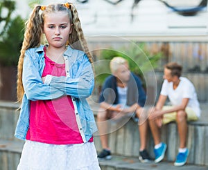 Upset girl after quarrel with playmates