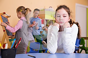 Upset girl in schoolroom during break