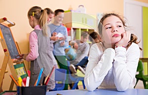 Upset girl in schoolroom during break