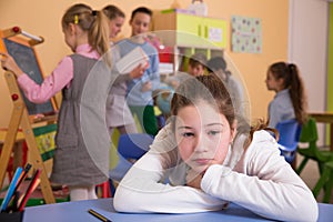 Upset girl in schoolroom during break