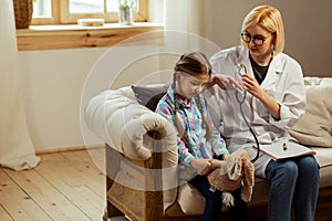 Upset girl sitting beside a good-looking blonde doctor photo