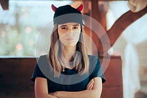 Upset Girlfriend Wearing a Devil Horned Hat Looking Displeased