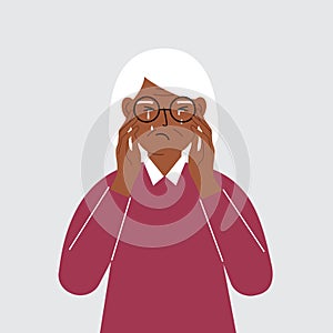 Upset grandmother cries and holds his head with his hands. The concept of resentment, pain and depression.