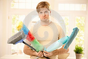 Upset guy with cleaning tools