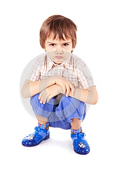 Upset little boy on white background