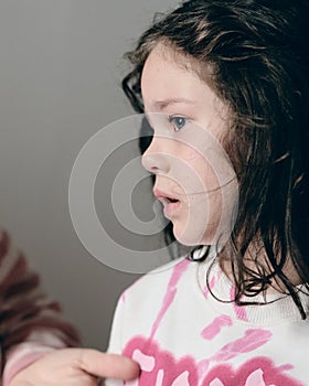 upset little girl being consoled by mom photo