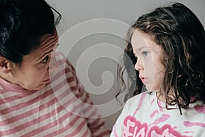 upset little girl being consoled by mom photo