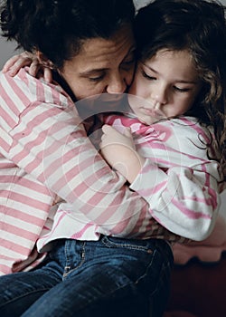 upset little girl being consoled by mom photo